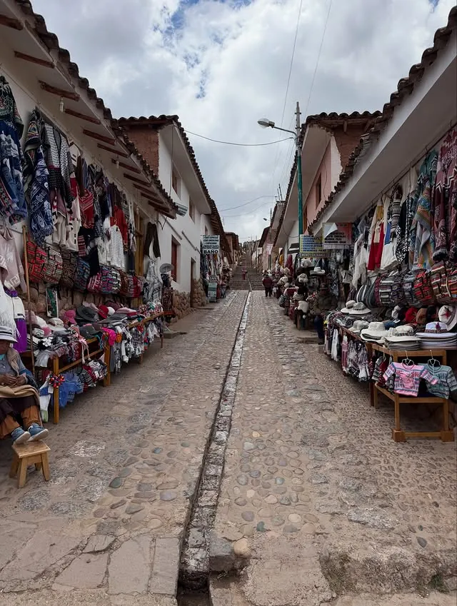 Calle empedrada y paisaje andino en Chinchero